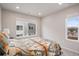 Cozy bedroom with a patterned quilt, a bright window view, and minimalist decor at 12283 W 57Th Ln, Arvada, CO 80002