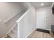 Bright entryway featuring wood floors, carpeted stairs, and a convenient storage unit at 12283 W 57Th Ln, Arvada, CO 80002