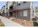 Stylish townhouse with modern gray brick and siding, complemented by a well-kept rock garden at 12283 W 57Th Ln, Arvada, CO 80002