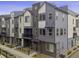 Modern townhome featuring a stylish multi-tone exterior and well-maintained landscaping at 12283 W 57Th Ln, Arvada, CO 80002