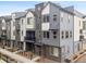 Modern townhouse exterior with gray siding, brick accents, and black trim details at 12283 W 57Th Ln, Arvada, CO 80002