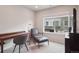 Well-lit home office with a sleek desk, comfortable chair, and large window offering natural light at 12283 W 57Th Ln, Arvada, CO 80002