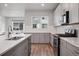 Sleek kitchen featuring modern appliances, ample counter space, and stylish gray cabinetry at 12283 W 57Th Ln, Arvada, CO 80002