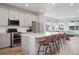 Open-concept kitchen featuring a large island, stainless steel appliances, and inviting breakfast bar seating at 12283 W 57Th Ln, Arvada, CO 80002
