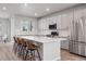 Bright kitchen with white cabinets, quartz countertops, and stainless steel appliances at 12283 W 57Th Ln, Arvada, CO 80002