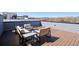 Spacious rooftop deck with comfortable furniture, offering stunning views of the mountains at 12283 W 57Th Ln, Arvada, CO 80002