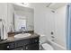 Clean bathroom featuring a shower-tub combo and a sleek vanity with countertop and ample lighting at 12860 Jasmine St # C, Thornton, CO 80602