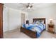 Bright bedroom showcases a large ceiling fan, wood-frame bed, and ample natural light from the adjacent window at 12860 Jasmine St # C, Thornton, CO 80602