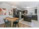 Well-equipped kitchen featuring stainless steel appliances, dark cabinetry, granite countertops, and an adjacent dining area at 12860 Jasmine St # C, Thornton, CO 80602