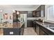 Well-equipped kitchen with stainless steel appliances, dark cabinets, and a functional layout for easy meal preparation at 12860 Jasmine St # C, Thornton, CO 80602