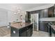 Updated kitchen featuring stainless steel appliances, a center island, and an adjacent dining area for convenient meals at 12860 Jasmine St # C, Thornton, CO 80602