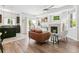 Open-concept living room featuring a fireplace, ceiling fan, and sliding door access to a balcony, blending indoor and outdoor living at 12860 Jasmine St # C, Thornton, CO 80602