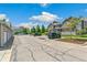 Exterior street view of townhomes with parking, mature trees, and manicured landscaping at 12860 Jasmine St # C, Thornton, CO 80602