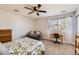 Light-filled bedroom with a ceiling fan, desk, chair, and a comfortable armchair at 10472 Grizzly Gulch, Highlands Ranch, CO 80129