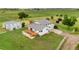 An aerial view of home on a large lot with outbuildings and fenced in yard at 14475 Lanewood St, Brighton, CO 80603