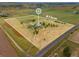 Aerial shot of 8.7 acres with a house, outbuildings, trees and open fields with a road on one side at 14475 Lanewood St, Brighton, CO 80603