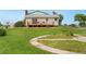 A large backyard featuring a wood deck, patio and lush lawn at 14475 Lanewood St, Brighton, CO 80603