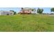 A grassy backyard features a charming two-story home with a wooden deck at 14475 Lanewood St, Brighton, CO 80603