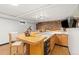 Finished basement bar area featuring a TV and barstools, perfect for entertaining at 14475 Lanewood St, Brighton, CO 80603