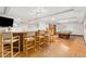 A spacious basement with a full bar setup, including barstools and a pool table for entertainment at 14475 Lanewood St, Brighton, CO 80603