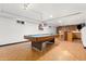 Finished basement showcasing a pool table, wet bar, and unique flooring, ideal for entertaining at 14475 Lanewood St, Brighton, CO 80603