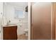 A clean bathroom with tiled walls, window, and a vanity with ample storage at 14475 Lanewood St, Brighton, CO 80603