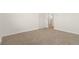 Bedroom with neutral carpet and white walls and trim; bathroom is accessed via a door at 14475 Lanewood St, Brighton, CO 80603