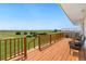A wood deck with views of fields and outbuildings at 14475 Lanewood St, Brighton, CO 80603