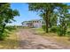 Two-story home with an attached garage, a well-maintained yard, and a long driveway at 14475 Lanewood St, Brighton, CO 80603