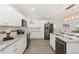 Updated kitchen with white cabinetry, granite countertops, and stainless steel appliances at 14475 Lanewood St, Brighton, CO 80603