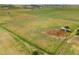 Expansive land featuring verdant grasses and structures, offering a vast canvas for development and outdoor pursuits at 14475 Lanewood St, Brighton, CO 80603