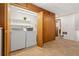 A well-equipped laundry room featuring a washer, dryer, built in storage and tile flooring at 14475 Lanewood St, Brighton, CO 80603