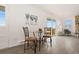 Living room area with a glass dining table and access to an outdoor deck at 14475 Lanewood St, Brighton, CO 80603