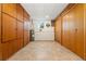 Basement storage room featuring built-in cabinets, laminate floor, and a small window at 14475 Lanewood St, Brighton, CO 80603