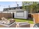Outdoor patio featuring a fire pit, artificial grass, string lights, and a movie screen at 2571 S Cherokee St, Denver, CO 80223