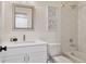 Clean bathroom featuring hexagonal tile and framed botanical art hanging on the wall at 2571 S Cherokee St, Denver, CO 80223