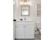 Well-lit bathroom featuring a modern vanity with storage and a framed mirror at 2571 S Cherokee St, Denver, CO 80223