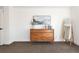 Bedroom with carpet, wooden dresser, art, and full-length mirror enhances a stylish and cozy space at 2571 S Cherokee St, Denver, CO 80223