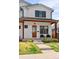 Close-up of a charming two-story home featuring a covered porch, black trimmed windows and inviting entrance at 2571 S Cherokee St, Denver, CO 80223