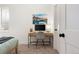 Minimalist home office setup with a sleek desk, mountain artwork, and a neutral color scheme at 2571 S Cherokee St, Denver, CO 80223