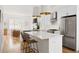 Beautiful kitchen featuring white cabinets, white quartz countertops, stainless steel appliances, and modern pendant lights at 2571 S Cherokee St, Denver, CO 80223