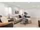Modern living room with neutral color palette, comfortable seating, and an adjacent exercise area at 2571 S Cherokee St, Denver, CO 80223
