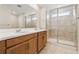 Bathroom with double vanity and glass-enclosed shower at 39731 Congress Ln, Elizabeth, CO 80107