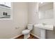 Powder room features a pedestal sink, mirror, and window at 39731 Congress Ln, Elizabeth, CO 80107