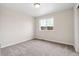 Neutral bedroom features a large window and plush carpeting at 39731 Congress Ln, Elizabeth, CO 80107