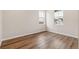 Bright bedroom featuring wood-look floors and two windows at 39731 Congress Ln, Elizabeth, CO 80107