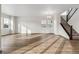 Bright living room with staircase featuring hardwood floors and large windows at 39731 Congress Ln, Elizabeth, CO 80107