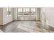 Bright living room featuring hardwood floors and three large windows at 39731 Congress Ln, Elizabeth, CO 80107