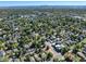 This aerial view showcases the neighborhood surrounding the home, with mature trees and Downtown Denver in the distance at 4110 Yates St, Denver, CO 80212