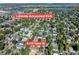 An aerial view shows the neighborhood with mature trees, surrounding 4110 Yates St, with Lakeside Amusement Park in the distance at 4110 Yates St, Denver, CO 80212